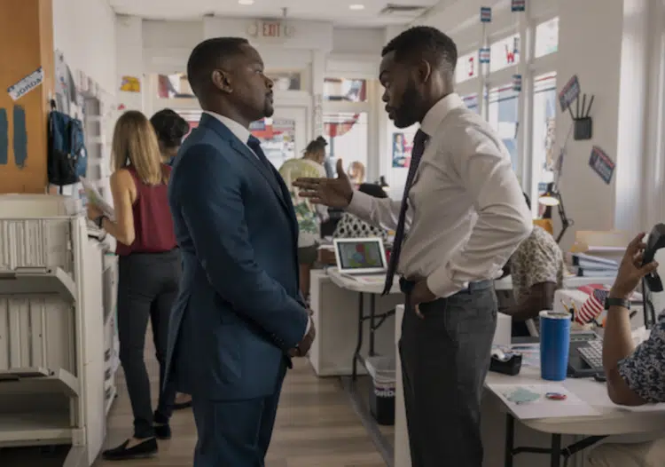 A Man in Full's characters Roger White and Wes Jordan standing in Jordan's election headquarters, standing and speaking to one another