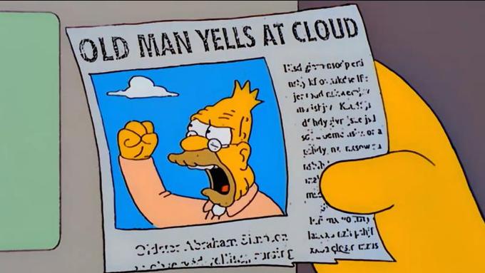 screenshot from the TV Show, The Simpsons. A cartoon hand is holding a newspaper clipping with the heading, Old Man Yells at Cloud with Grampa Simpson in a photo next to the article, shaking his first and looking angrily up at a cloud in the sky.