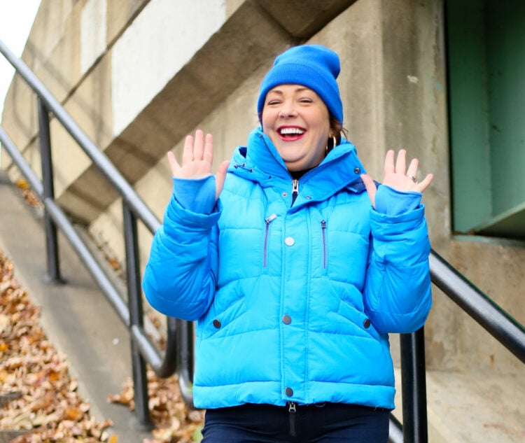 Alison laughing with her hands up in the air, showing the cuffs with thumb holes